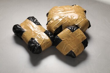 Packages with narcotics on grey textured table