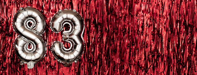 Silver foil balloon number eighty-three. Birthday or anniversary card with the inscription 83....