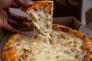pizza slice taking short, fast food, obesity, danger for health, huge quantity of cheese