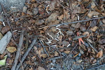 a huge number of cigarette waste in the street side Road