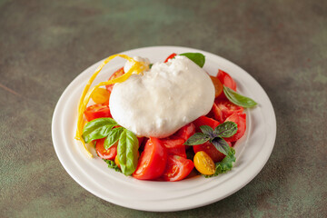 Italian cheese burrata with tomatoes on a plate