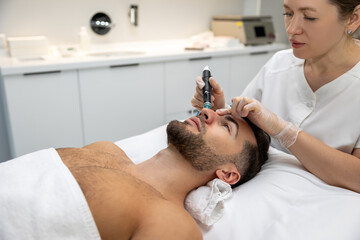Obraz na płótnie Canvas Man having cosmetological procedures in a beauty clinic