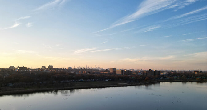 Nyc Skyline View In The Distance At Sunset (aerial Drone Shot From Corona Flushing Meadows Park In Queens) Midtown Manhattan Skyscrapers Silhouette At Golden Hour (meadow Lake, Water) Far Away