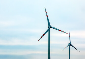 Wind turbine station windmill park next to the road in Austria in cloudy weather.