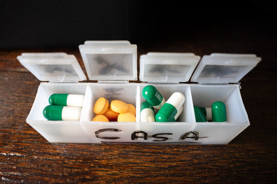 Orange pills and green pills with white, pill organizer