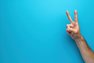 Male hand gestures with two fingers raised on blue background