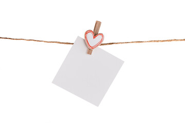 Empty paper note hanging on a rope isolated on a white background
