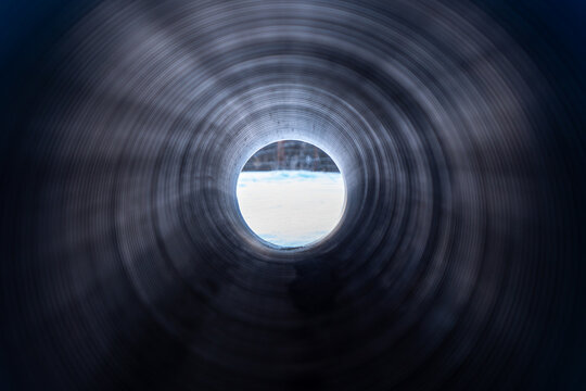 Corrugated plastic drain pipe shot from inside.