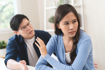 Family problem concept, Asian wife and husband sitting back to back in the living room at home have...