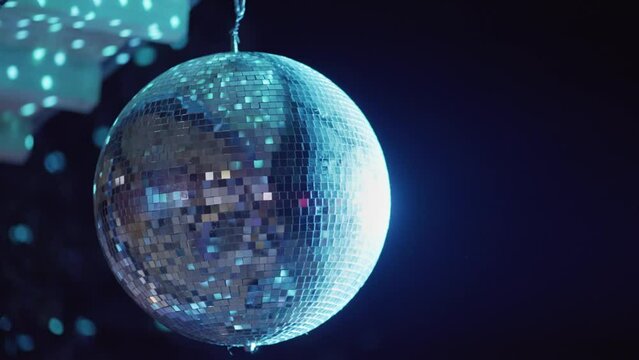 Party disco mirror ball reflecting colorful lights at night celebration event