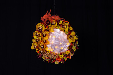 orchids decorative in round shape with silky center and star lighting on black background