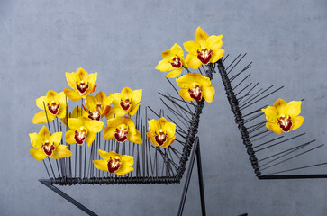 orchids on decorative metal star-shaped black frame