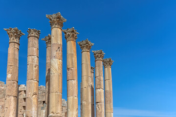 Columns of the Temple of Zeus against a blue sky. Ruins of Jerash ,  Free space for your text is ready. Jordan.