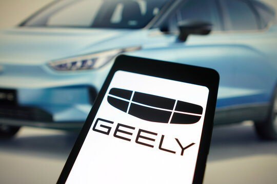January 29, 2024, Brazil. In this photo illustration, the Geely Automobile logo is displayed on a smartphone screen and in the background, an electric car from the brand.