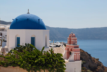 Greek Orthodox church of St. Nicholas on the background waters of the Aegean sea in Oia town on...