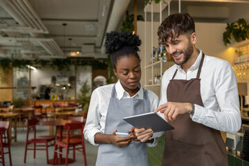 Pizzeria worker standing together and discussing something