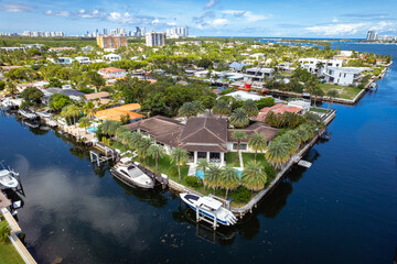North Miami, Florida, USA - Aug 12, 2023: Aerial view of luxurious houses along a canal in Keystone...