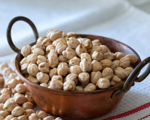 Raw chickpeas in a bowl macro view 