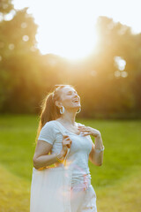 Fototapeta premium happy elegant 40 years old woman in white shirt enjoying