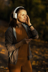 relaxed female in park listening to music