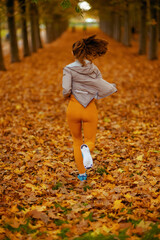 Seen from behind woman in fitness clothes in park jogging
