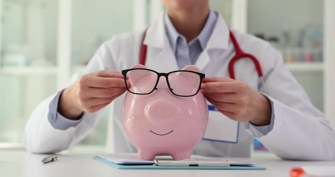 Female doctor puts glasses on piggy bank and recommends saving money for health insurance services