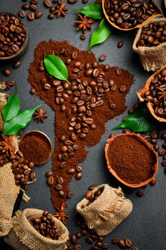 Aromatic coffee beans. Set of coffee beans in the shape of a world map of South America. Top view. On a dark background.