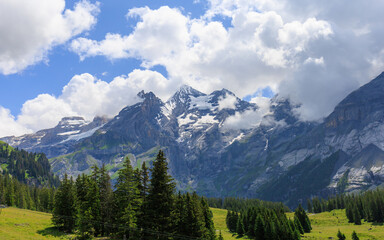 View of Kandersteg Alps with snowy peaks covered with clouds