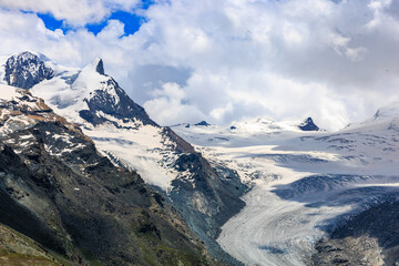 Fototapeta na wymiar Alpine mountain view Rothorn peak glacier on blue sky white clouds background