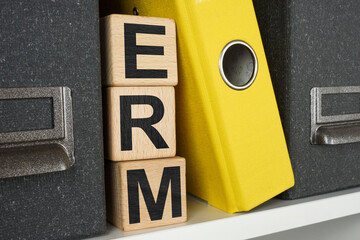 Shelf with folders and cubes ERM Enterprise risk management.
