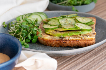 Savory Avocado Toast Topped With Fresh Greens on a Modern Ceramic Plate