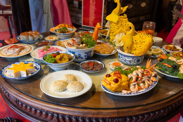 Tet tray. Full of traditional dishes. Chinese new year festival table with asian food. Vietnamese food for Tet holiday in lunar new year. Text on food meaning happy and peaceful.