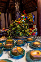 Tet tray. Full of traditional dishes. Chinese new year festival table with asian food. Vietnamese food for Tet holiday in lunar new year. Text on food meaning happy and peaceful.