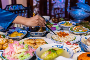 Tet tray. Full of traditional dishes. Chinese new year festival table with asian food. Vietnamese food for Tet holiday in lunar new year. Text on food meaning happy and peaceful.