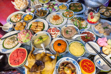 Tet tray. Full of traditional dishes. Chinese new year festival table with asian food. Vietnamese food for Tet holiday in lunar new year. Text on food meaning happy and peaceful.