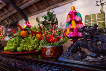 Close up of a watermelon on the altar of ancestors during Tet holidays in Vietnam. Golden text on paper in photo meaning happy and peaceful