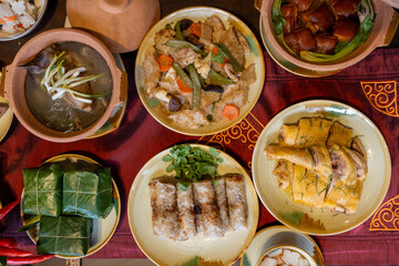 Fototapeta na wymiar Tet tray. Full of traditional dishes. Chinese new year festival table with asian food. Vietnamese food for Tet holiday in lunar new year. Text on food meaning happy and peaceful.