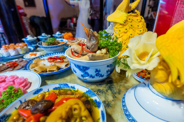Tet tray. Full of traditional dishes. Chinese new year festival table with asian food. Vietnamese food for Tet holiday in lunar new year. Text on food meaning happy and peaceful.