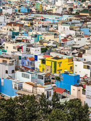 Fototapeta premium Ho Chi Minh City, Vietnam - Dense urban landscape with colorful houses and rooftops, conveying a bustling city atmosphere.
