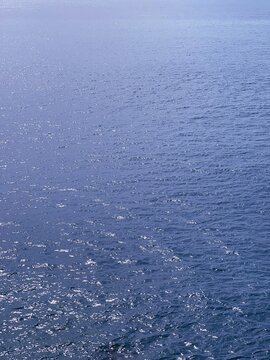 Blue sea water glittering surface vertical. 
