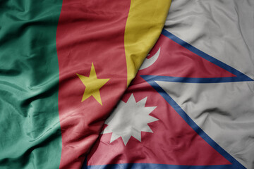 big waving national colorful flag of nepal and national flag of cameroon .