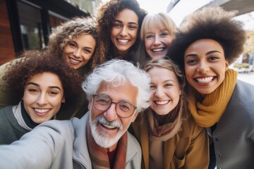 A group of people gathered together to take a selfie. Perfect for capturing fun and memorable moments with friends and family. Ideal for social media and technology-related concepts