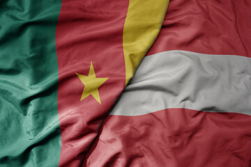 Obraz premium big waving national colorful flag of austria and national flag of cameroon .