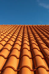 Clay tile roof. New roofing made of orange clay tiles