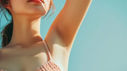 Tuinposter Closeup young beautiful woman showing armpit with smooth clean skin on solid background © SITI