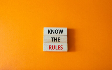 Know the rules symbol. Wooden blocks with words Know the rules. Beautiful orange background....