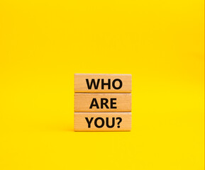 Who are You symbol. Concept words Who are You on wooden blocks. Beautiful yellow background....