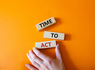 Time to Act symbol. Wooden blocks with words Time to Act. Beautiful orange background. Businessman...