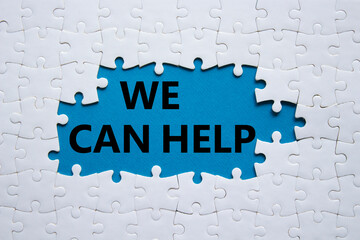 We can help symbol. Concept words We can help on white puzzle. Beautiful blue background. Business and We can help concept. Copy space.