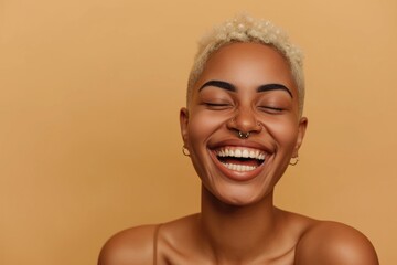 Happy young Black woman beauty female model, cool gen z short-haired blonde African girl with healthy face skin nose piercing laughing looking at camera isolated at beige background.